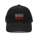 Front view of a black corduroy baseball cap with a curved brim and structured crown. Centered on the front panel, the word ‘MORBID’ appears stacked three times in embroidered capital letters: the top in white, the middle in white slightly offset, and the bottom in bold red. The corduroy’s vertical ridges create subtle shadows across the front and brim.