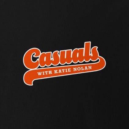Close up of the front side orange and white 'Casuals WITH KATIE NOLAN' logo in retro font.
