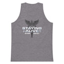 Flat lay of a heather gray tank top featuring a centered graphic of a black caduceus symbol—a winged staff with two snakes coiled around it—commonly associated with medicine and healing. Below there's white text that reads 'STAYING ALIVE', accented by white EKG heartbeat lines, with the names 'JON GABRUS' and 'ADAM PALLY' printed underneath in smaller white capital letters.