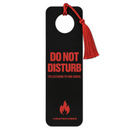 Front product view of a black rectangular door-hanger-style bookmark with rounded corners and a circular cutout near the top. A red cord and tassel loop through the cutout. Red text reads ‘DO NOT DISTURB’ with ‘I’M LISTENING TO VIBE CHECK.’ below. Near the bottom is a red flame graphic above 