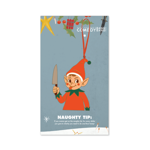 Blue backer card decorated with holiday greenery and the text ‘Scott Aukerman’s Comedy Bang! Bang!’ at the top. The ornament shows a mischievous elf in a red outfit holding a knife, hanging from a red ribbon. Text at the bottom reads ‘NAUGHTY TIP: If you wanna get on the naughty list, for every dollar you give to charity you need to do one floor hump!’