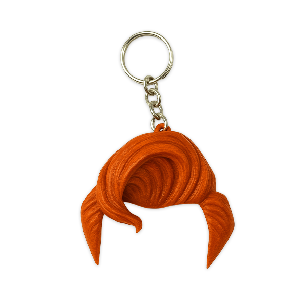 A product image of a keychain featuring a sculpted tuft of orange hair on a metal chain and keyring, displayed against a plain white background.