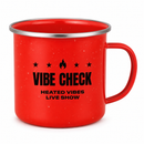 Angled product view of a bright red speckled camp mug with a silver metal rim and red handle, showing the red interior. The black front graphic features four stars surrounding a central flame icon above the text ‘VIBE CHECK’ and ‘HEATED VIBES LIVE SHOW’.