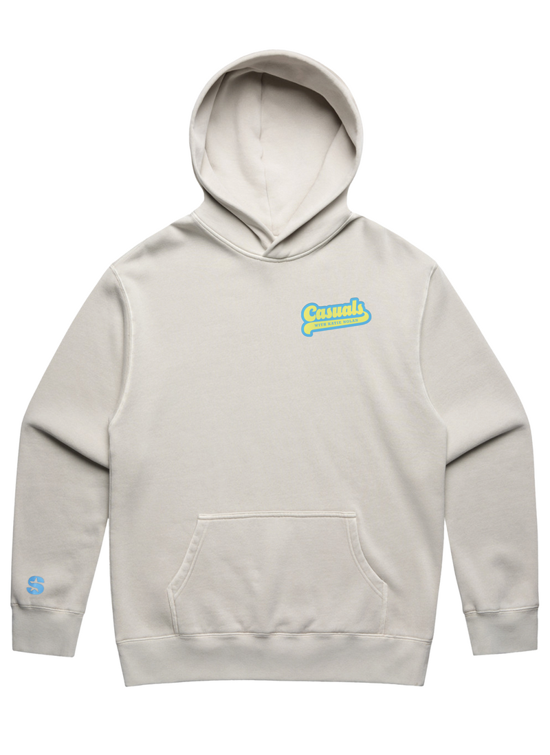 Front view of an off-white hoodie with kangaroo pocket, featuring the blue and yellow ‘Casuals with Katie Nolan’ logo on the left chest and a small blue SiriusXM S-Star logo on the left wrist cuff.