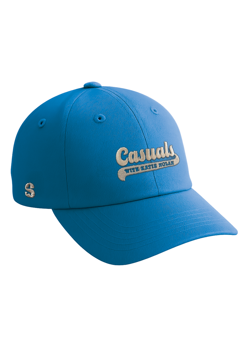 Three-quarter front view of a bright blue baseball cap embroidered with the ‘Casuals with Katie Nolan’ logo in beige thread across the front and the ‘S-Star’ SiriusXM logo on the left side.