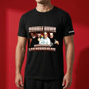 Man wearing a black short-sleeve T-shirt against a red background, featuring graphic with text ‘DOUBLE DOWN’ and ‘BUSTED OPEN LAS VEGAS SLAM’ with four men in front of a fiery backdrop and ‘SiriusXM’ logo on sleeve.