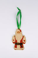 Ornament shaped like Santa Claus wearing his classic red suit, glasses, and green ribbon, holding up both middle fingers.