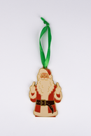 Ornament shaped like Santa Claus wearing his classic red suit, glasses, and green ribbon, holding up both middle fingers.