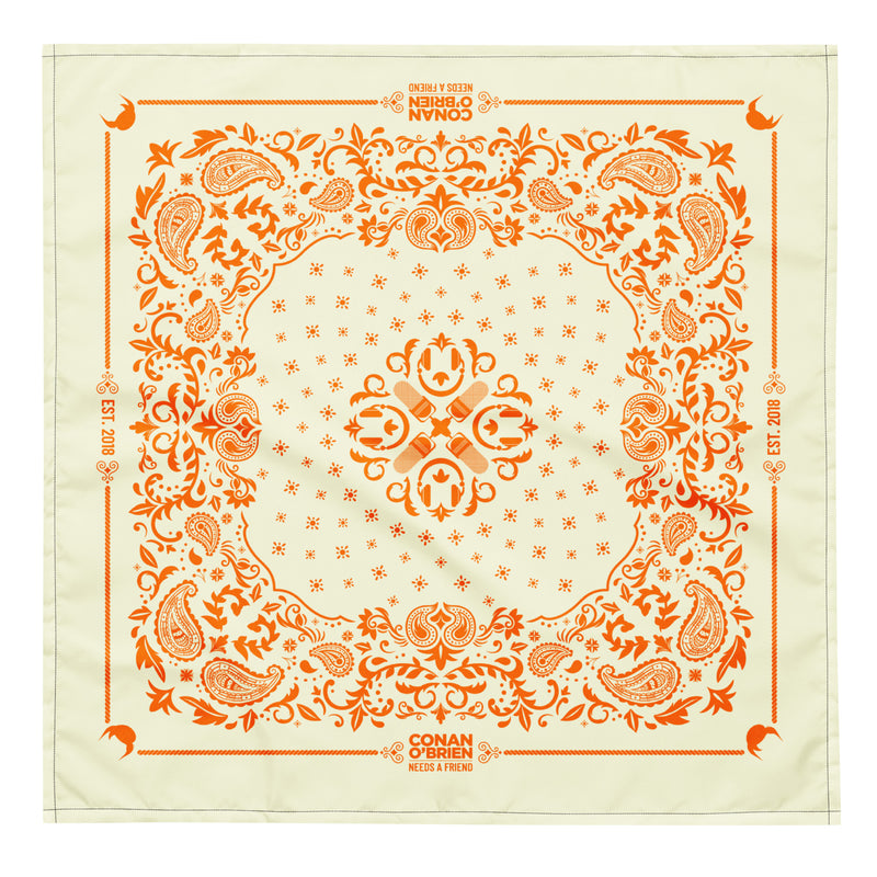 Orange decorative bandana featuring intricate paisley and floral patterns with text related to Conan O'Brien.