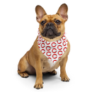 French Bulldog wearing a decorative bandana with a red and white pattern sitting against a black background.