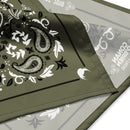 Green bandana with intricate black and white paisley and floral designs, featuring Conan O'Brien's branding and establishment year.