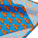 Colorful fabric pattern featuring 'Comedy Bang! Bang!' logo with cartoonish tricycles on a blue background