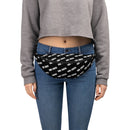 A person wearing a grey cropped sweatshirt and jeans with a black fanny pack strapped around the waist. The bag features an all-over diagonal white 'VIBE CHECK' print.