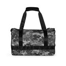 Camouflage duffel bag with black straps and zipper closure on a white background.