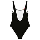 A black one-piece swimsuit displayed flat with a white interior lining and a deep scoop back; a portion of the colored stripe pattern is visible at the neckline edge.