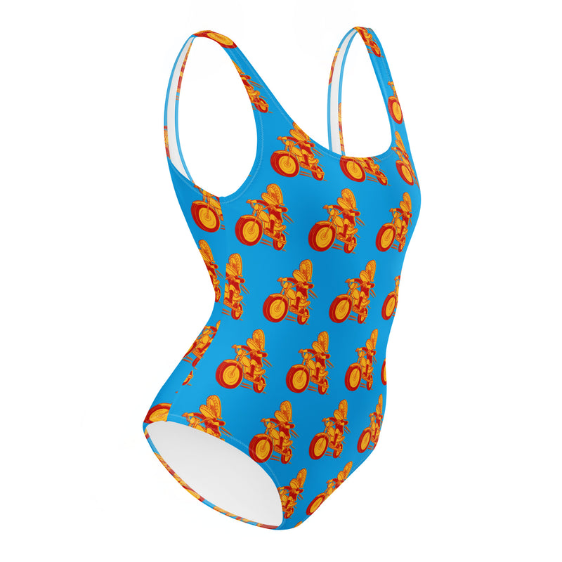 Colorful one-piece swimsuit featuring Comedy Bang! Bang! logo with vibrant orange and yellow bicycle patterns on a blue background.