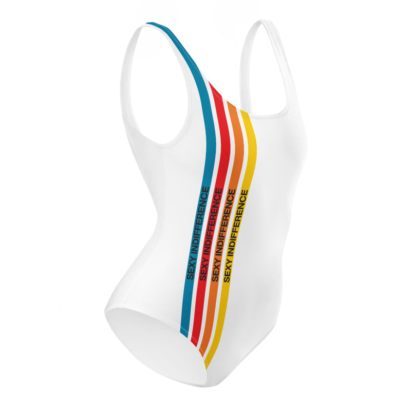A white one-piece swimsuit featuring four vertical stripes in blue, red, orange, and yellow along the left side, each with the phrase 'SEXY INDIFFERENCE' printed in black text.