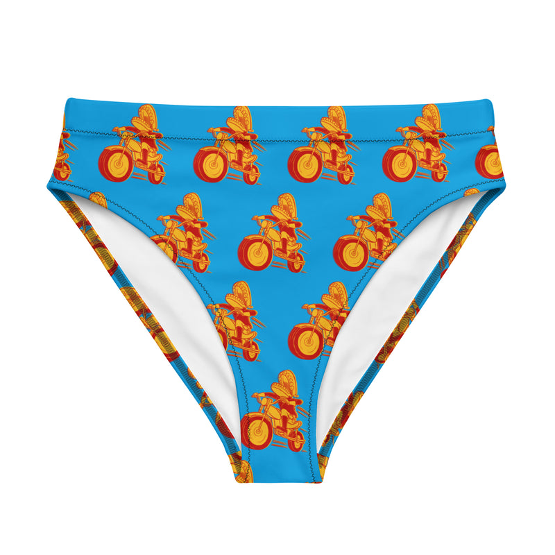 A blue high-waisted bikini bottom featuring a repeating red and yellow pattern of Comedy Bang Bang's classic Motormouth character, with chattering teeth for a head riding a motorcycle, shown flat from the front with the inner white lining slightly visible at the leg openings.