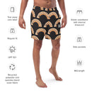 A man wearing black mid-length swim trunks with a rainbow 'BYEEEEEEE' print and white 'SiriusXM' logo on the leg, surrounded by icons highlighting product features like 'UPF 50+', 'Recycled fabric', 'Side pockets', and 'Elastic waistband with internal drawcord'.