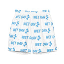 Front view of white swim trunks with an elastic waistband. The fabric is patterned with repeated light blue ‘WET DAY’ text and splash icons scattered across the surface. The shorts have a relaxed fit designed for swim or casual wear.
