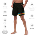 A man wears black swim trunks with colorful stripes and 'SEXY INDIFFERENCE' text near the hem, surrounded by icons indicating features such as 'UPF 50+', 'Side pockets', 'Recycled fabric', and 'Elastic waistband with drawcord'.