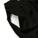 A close-up of the side pocket of black swim trunks, showing the interior white mesh lining and gathered elastic waistband.