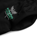 A detail shot of the joggers' pocket area and drawstring, focusing on the embroidered 'STAYING ALIVE' design and caduceus graphic in gray and green on smooth black fabric.