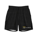 A pair of black men's swim trunks featuring a white grid pattern and the text '99% INVISIBLE' in white and yellow near the bottom right hem.