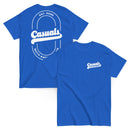 Royal blue short-sleeve t-shirt shown from both angles. Front: small white chest logo with 'Casuals' and 'WITH KATIE NOLAN' below. Back: large white oval outline with 'Casuals' in bold, 'EST. 2025' above, and 'WITH KATIE NOLAN' curved below.