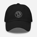 black baseball cap featuring a circular embroidered logo of an illustrative Conan face.