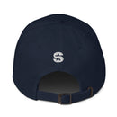 The back view of a navy blue dad hat showing a white embroidered 'S' logo above an adjustable strap with a brass buckle.