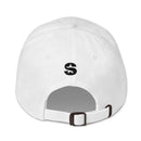 A white dad hat viewed from the back, featuring a black embroidered 'S' logo above a white adjustable strap with a brass buckle.