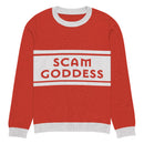 A red sweater with gray cuffs and collars featuring the text 'SCAM GODDESS' against a grey stripe on the front.
