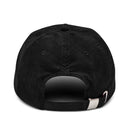 Back view of a black corduroy cap with an adjustable strap and logo detail on the side.