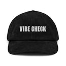 Black corduroy cap with white text reading 'VIBE CHECK' on the front.