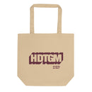 Cream colored canvas tote bag featuring maroon outlined graphic of 'HDTGM' initials and a smaller 'How Did This Get Made?' logo below.