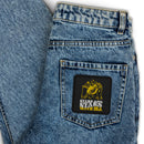 Denim jeans pocket featuring a graphic patch with hands, stars, and the text 'Stars and Stars with ISA'.