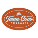 Team Coco' Podcasts logo featuring an orange oval design with white embroidered text.