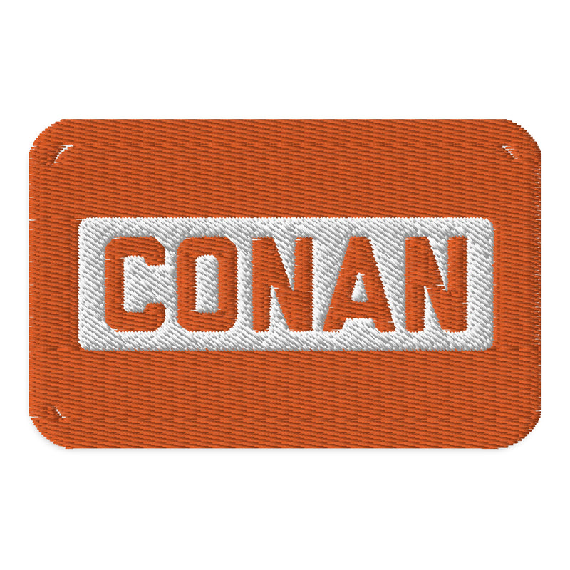 Embroidered patch with the word 'CONAN' in bold letters on a textured orange background.