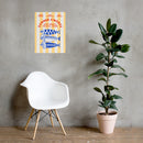 A 'Summer S’mores with Conan & the Chill Chums' poster is displayed on a gray concrete wall above a modern white chair and next to a tall potted rubber plant in a minimalist room.