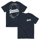 Navy short-sleeve t-shirt shown from both angles. Front: small white chest logo with 'Casuals' and 'WITH KATIE NOLAN' below. Back: large oval outline with 'Casuals' in bold, 'EST. 2025' above, and 'WITH KATIE NOLAN' curved below.
