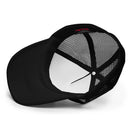 The interior of a black foam trucker hat with a white front panel and black mesh sides, showing the inside stitching and manufacturer's tag.