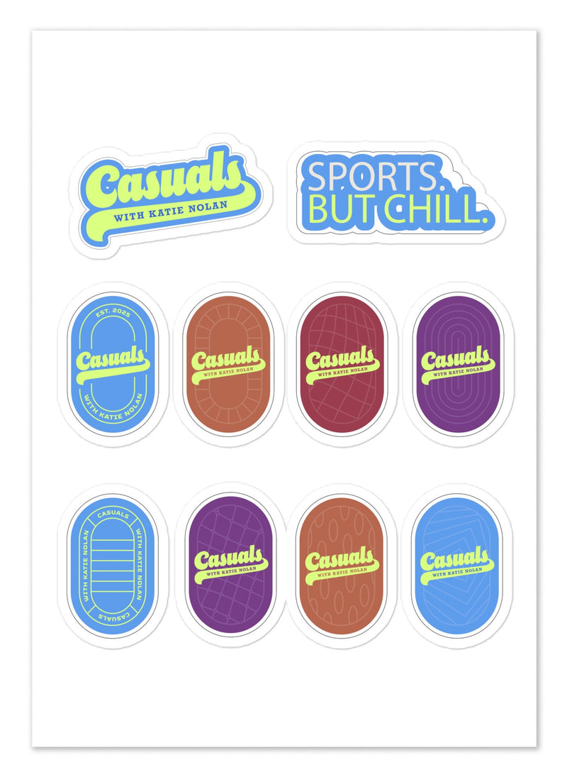 Flat lay front view of a rectangular white sticker sheet featuring ten colorful 'Casuals with Katie Nolan' stickers. The designs include two text stickers at the top reading 'Casuals WITH KATIE NOLAN' in yellow and blue, and 'SPORTS. BUT CHILL.' in blue and yellow, followed by eight oval logo stickers in blue, red, purple, and brown color variations.