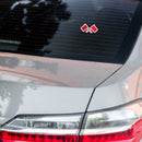 rear view of a car with a sticker featuring two red flags on a tinted window.