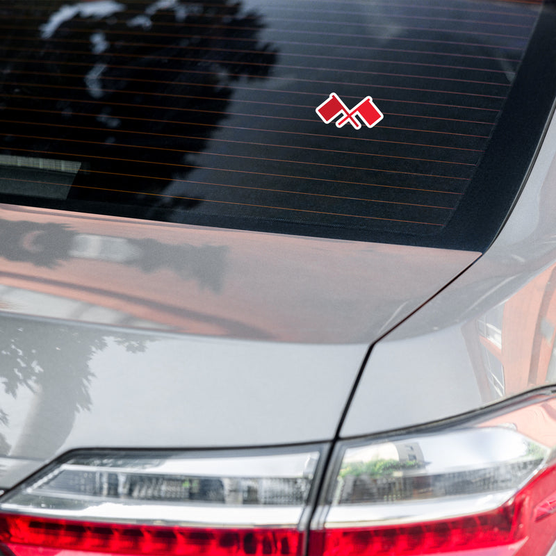 rear view of a car with a sticker featuring two red flags on a tinted window.