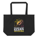 Black tote bag featuring colorful hands holding a celestial object with stars and text saying 'stars and stars with isa'.