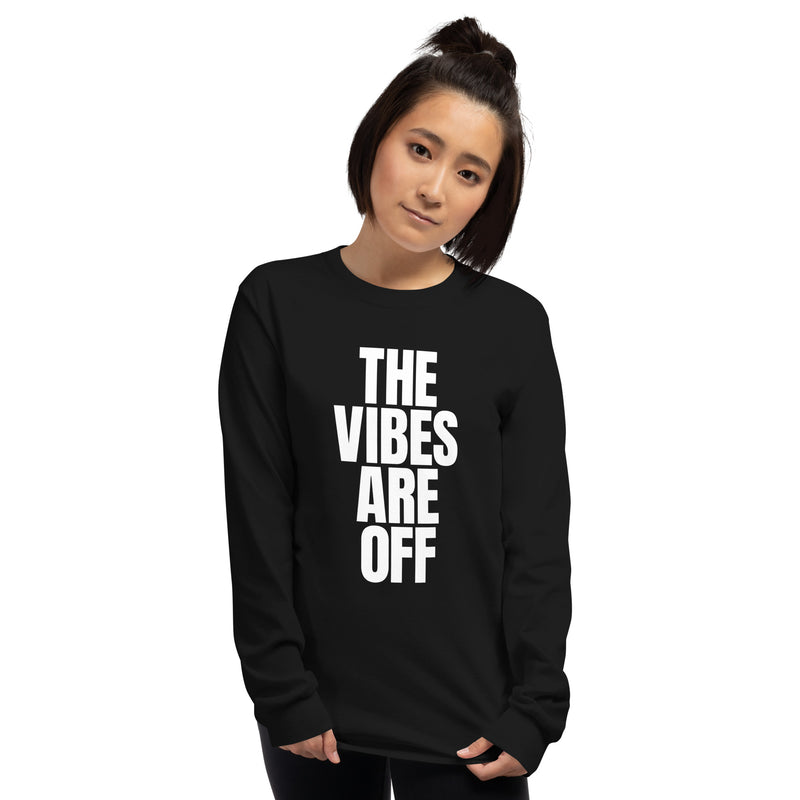A woman wearing a black long sleeve shirt with large white vertical text that reads 'THE VIBES ARE OFF' on the front.