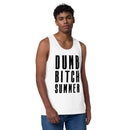 Male model stands against a white background wearing a white tank top with bold black vertical text that says 'DUMB BITCH SUMMER.'
