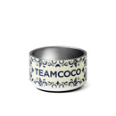 Ceramic pet bowl featuring a decorative design and the logo 'TEAMCOCO' in bold letters