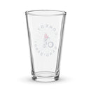 Pint glass featuring a design with the logo 'Comedy Bang! Bang!' and an illustration of a character on a motorcycle.